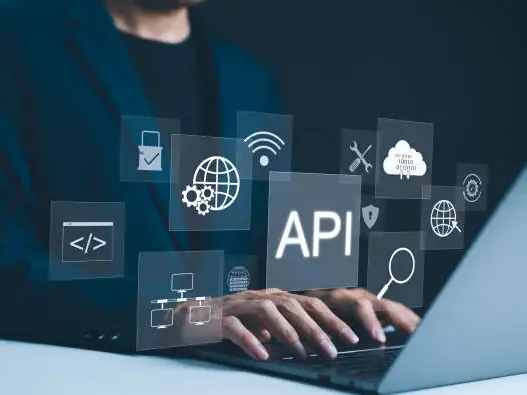 Hands typing on a laptop beneath floating interface panels with connection and settings icons